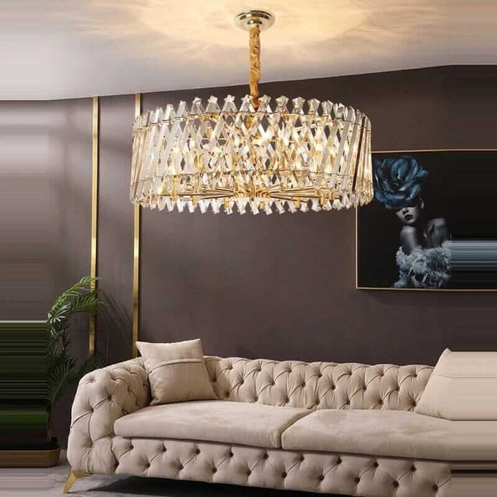 Luxurious crystal chandelier above a beige tufted sofa in a modern living room setting.