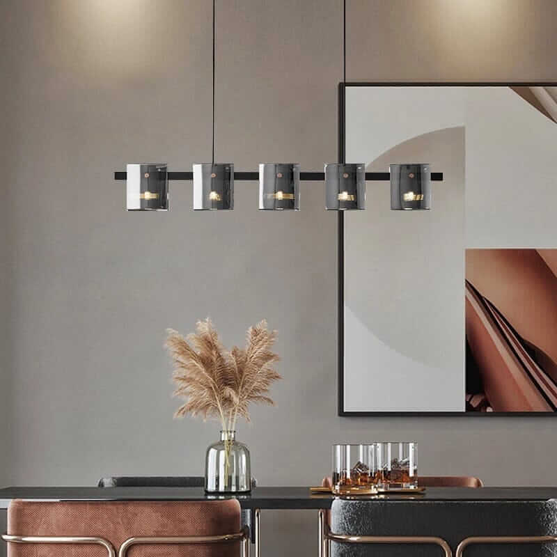 Modern LED chandelier illuminating a stylish dining area with a decorative vase and abstract art.