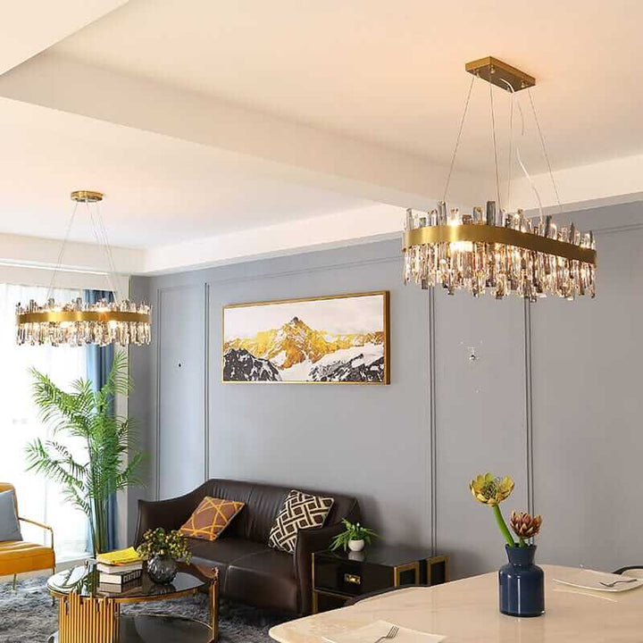 Gold crystal chandeliers illuminate a modern living room with elegant decor and stylish furnishings.