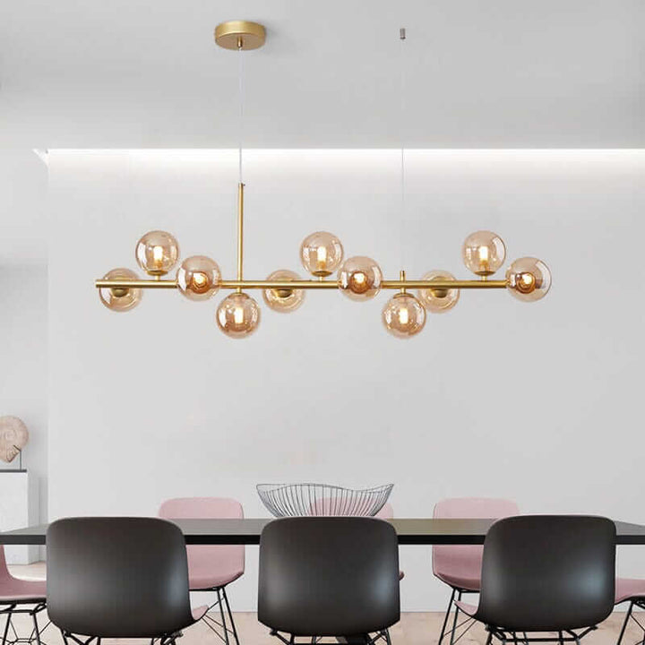 Elegant bubble chandelier with gold accents illuminating a modern dining space.