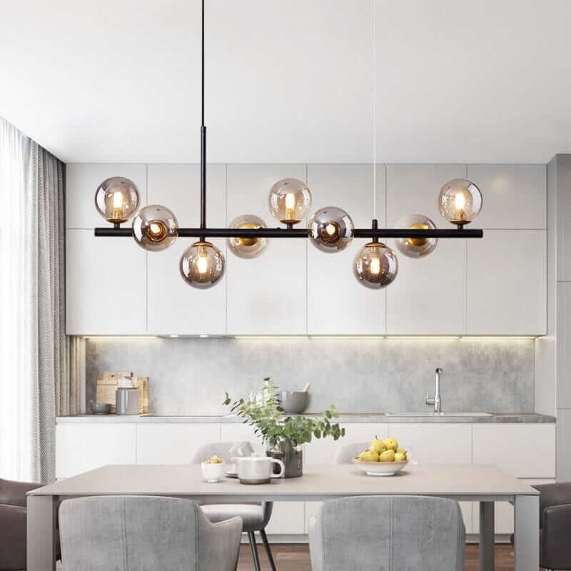 Stylish Bubble Chandelier illuminating a modern kitchen with gray cabinetry and a dining table.