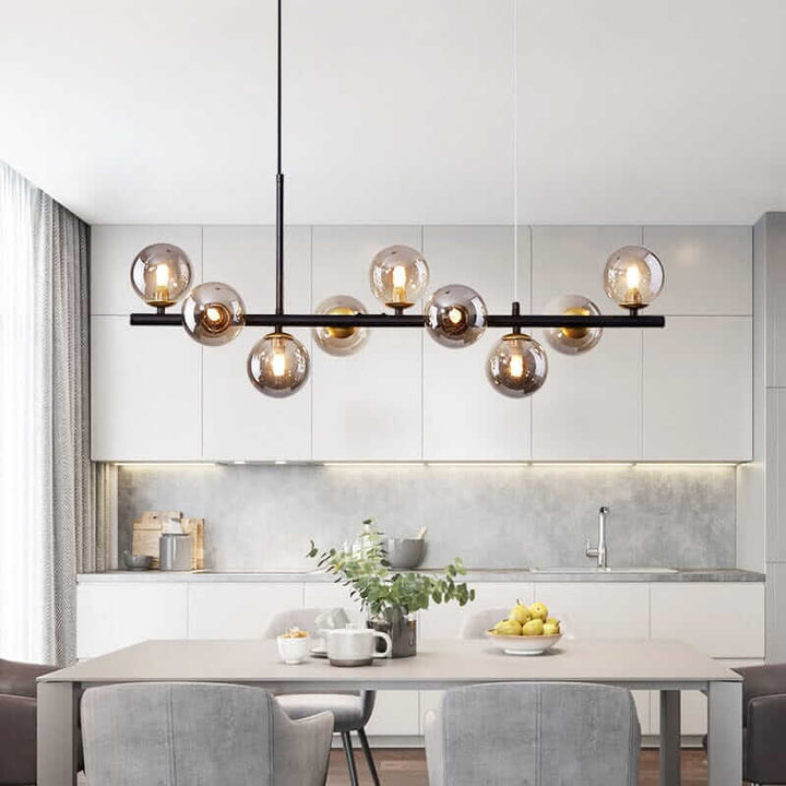 Stylish Bubble Chandelier illuminating a modern kitchen with gray cabinetry and a dining table.