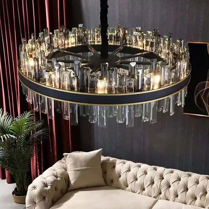 Elegant foyer chandelier with crystal accents above a stylish beige sofa, adding sophistication to the living space.