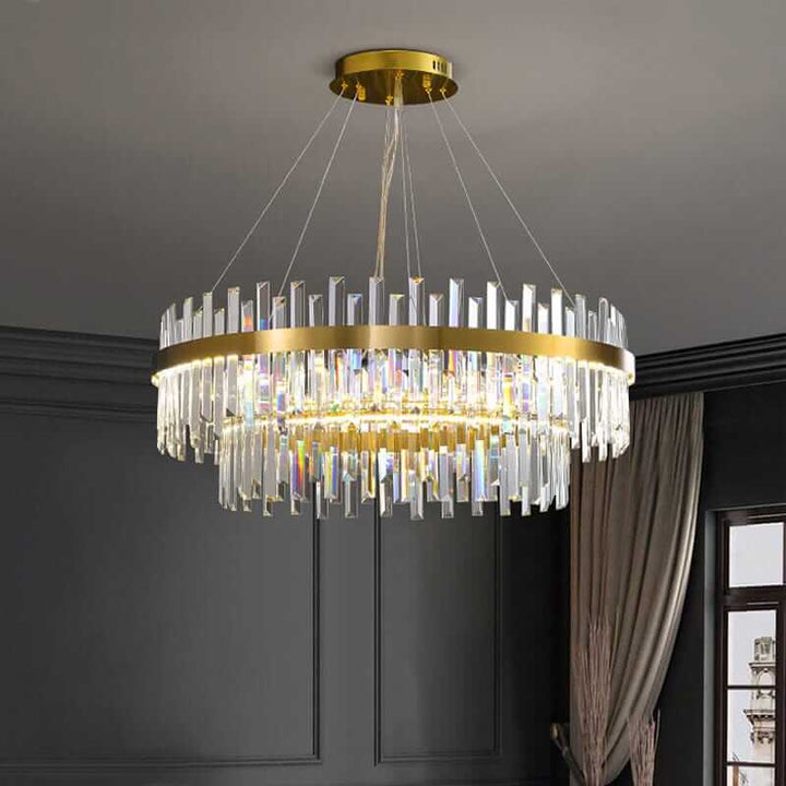 Foyer chandelier featuring gold accents and elegant crystal prisms for a modern interior ambiance.