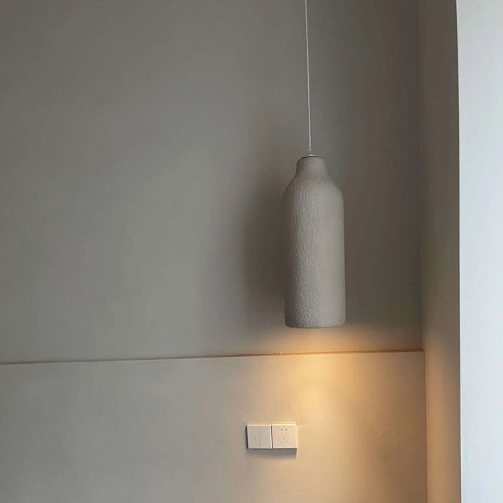 Wabi Sabi pendant light hanging in a minimalist interior, showcasing a modern design with soft lighting.