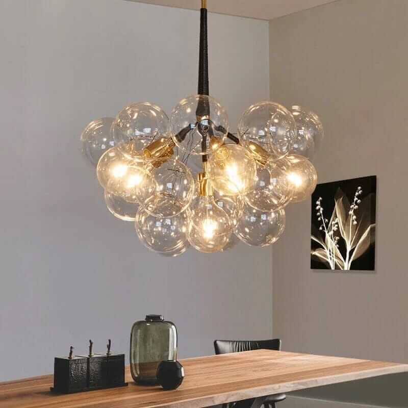 Bubble chandelier featuring glass orbs, illuminating a chic dining space with Scandinavian design.