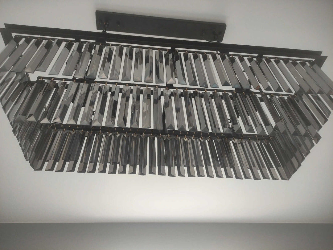 Elegant black chandelier with intricate geometric design, perfect for creating a mesmerizing ambiance in any home.