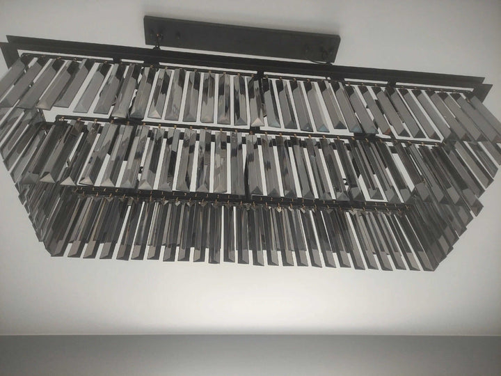 Elegant black chandelier with intricate geometric design, perfect for creating a mesmerizing ambiance in any home.