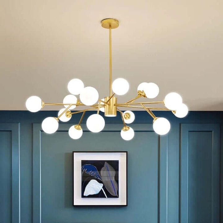 Luxury bubble chandelier hanging in a modern living room with blue walls and stylish furniture.