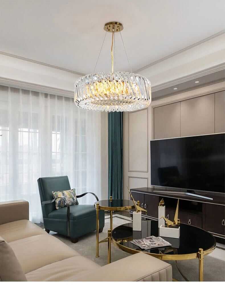 Stylish entryway chandelier with gold finish and crystal accents illuminating modern living room decor.