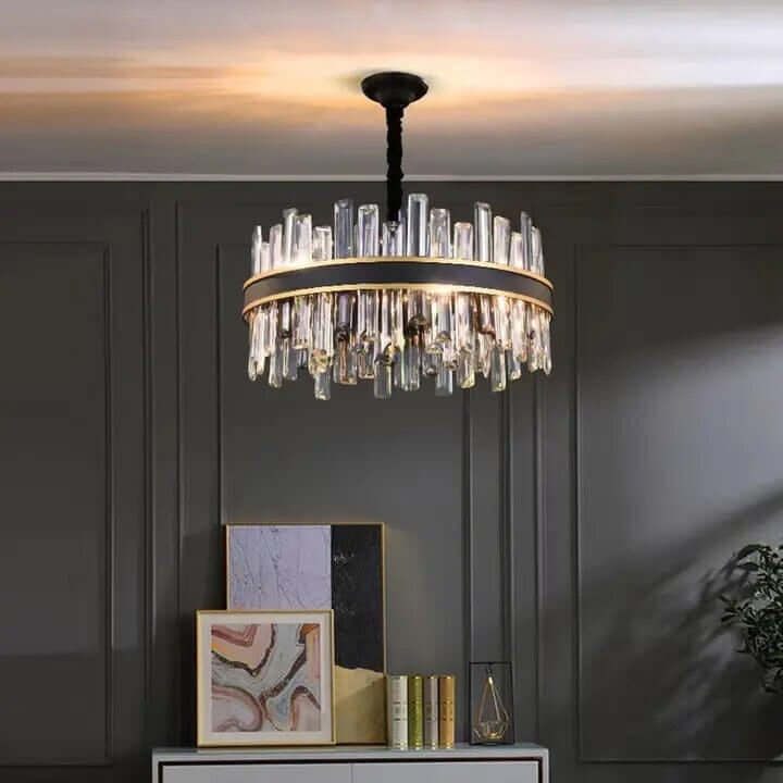 Foyer chandelier with crystal design illuminating modern room décor and elegant cabinetry.