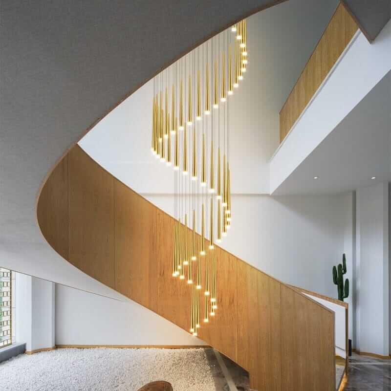 Stylish staircase chandelier illuminating a modern interior with sleek wooden stairs and contemporary design elements.