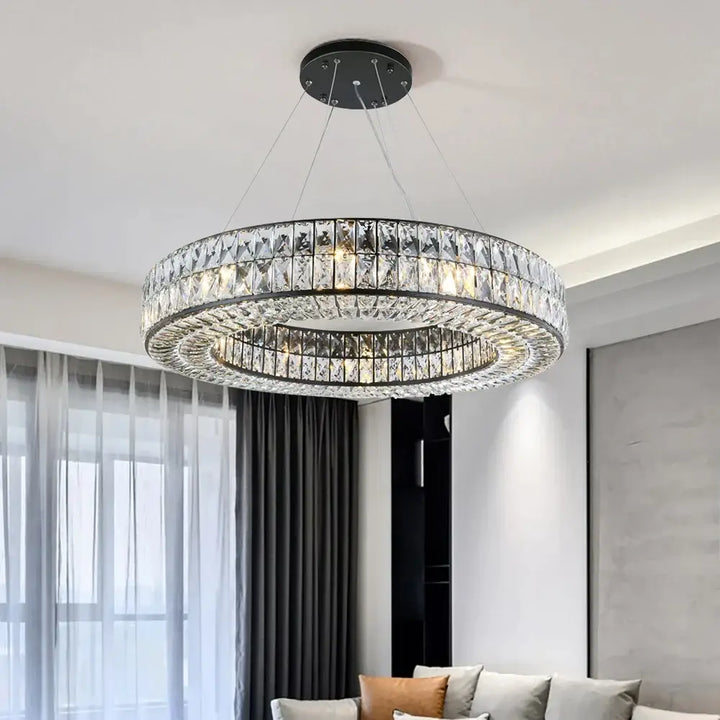 Angoona round modern crystal chandelier hanging in a stylish living room, reflecting luxury and elegance.