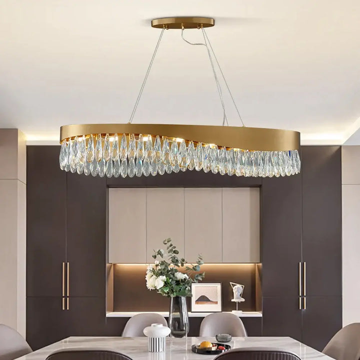 Gold oval LED crystal chandelier hanging in modern living room decor, enhancing luxury ambiance.