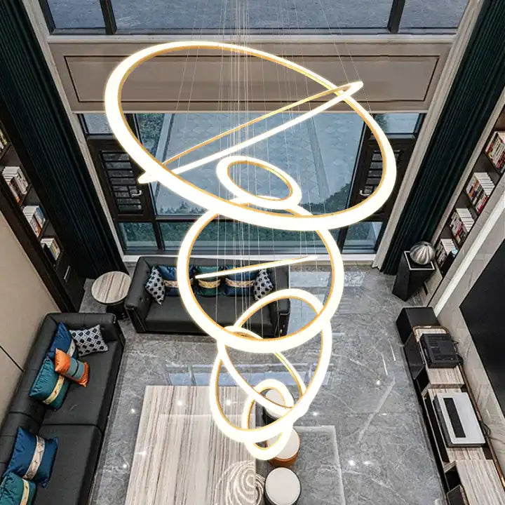 Modern 5-ring LED chandelier suspended in a stylish living room with elegant decor.