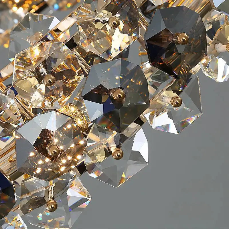 Close-up of a luxurious entryway chandelier featuring sparkling crystals and elegant gold accents.