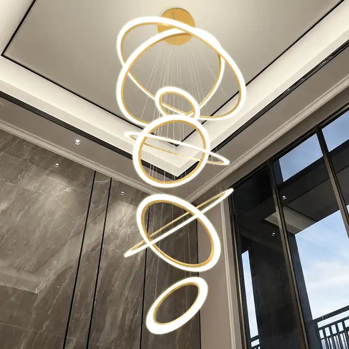 Modern 5-ring LED chandelier hanging from the ceiling, showcasing sleek design and illuminating a stylish space.