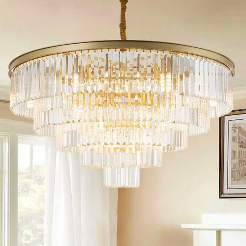 Elegant round golden crystal chandelier illuminating a stylish interior, showcasing luxury and sophistication.