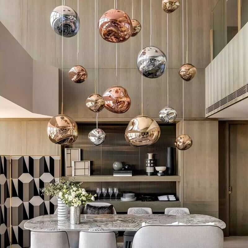Stylish foyer chandelier featuring cascading glass orbs in a modern interior design setting.