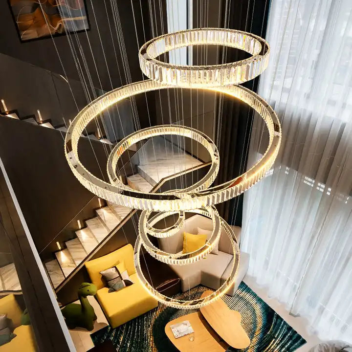 Elegant LED crystal chandelier with circular rings illuminating a modern living space.