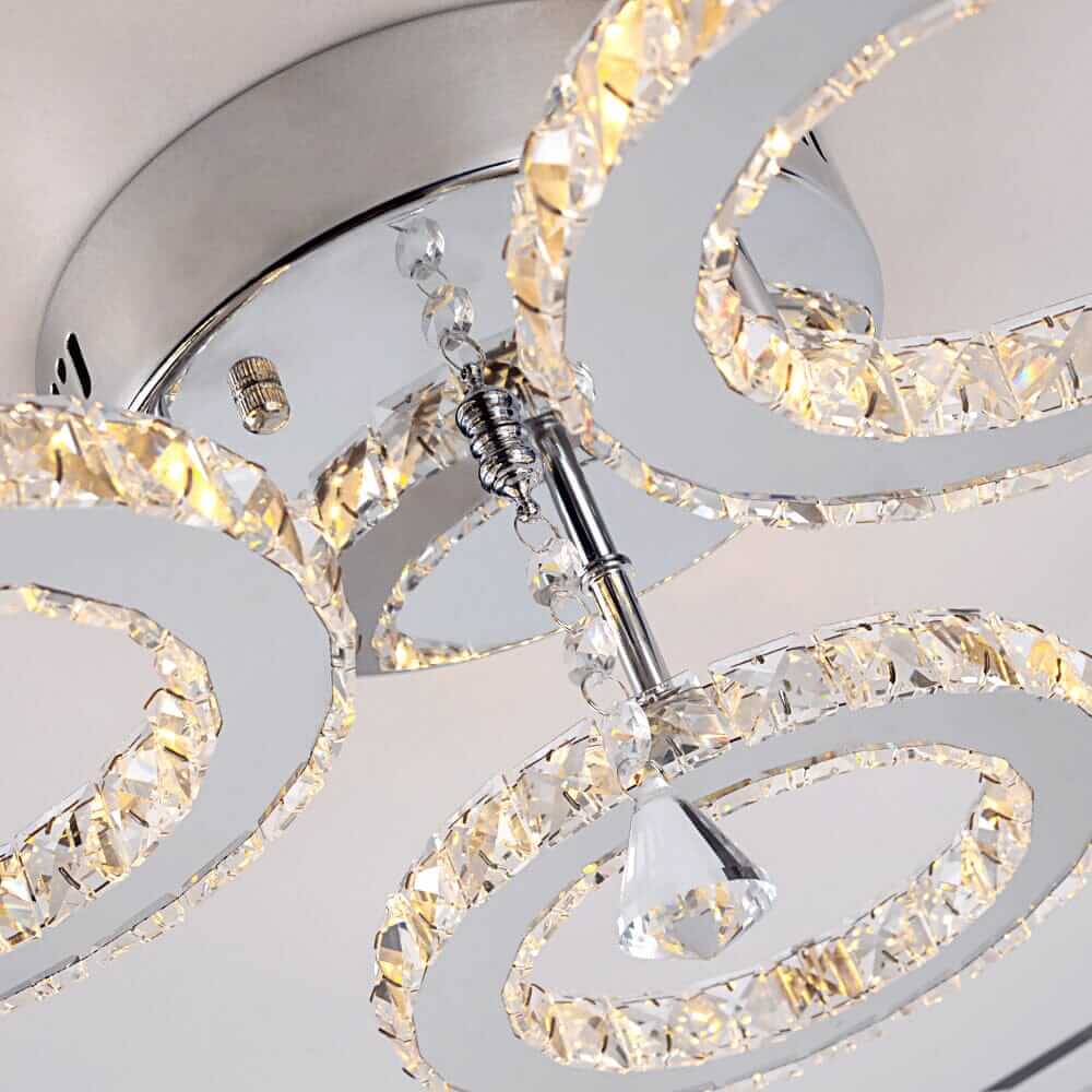 Close-up of a small crystal chandelier featuring shimmering circular tiers and polished chrome details.