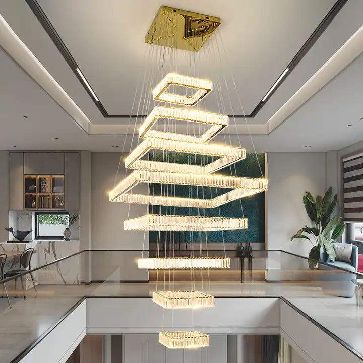 Modern LED foyer chandelier with sleek square design illuminating a staircase in a contemporary home.