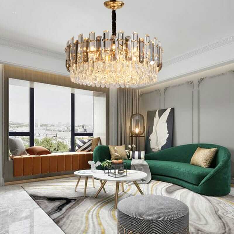 Modern interior showcasing a luxurious chandelier above a stylish green sofa, enhancing elegance in the living room.