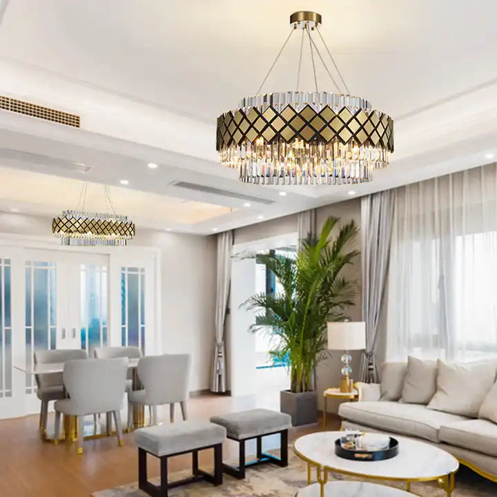 Elegant Bindi Crystal LED Hanging Light illuminating a modern living room setting with cozy decor and plants.