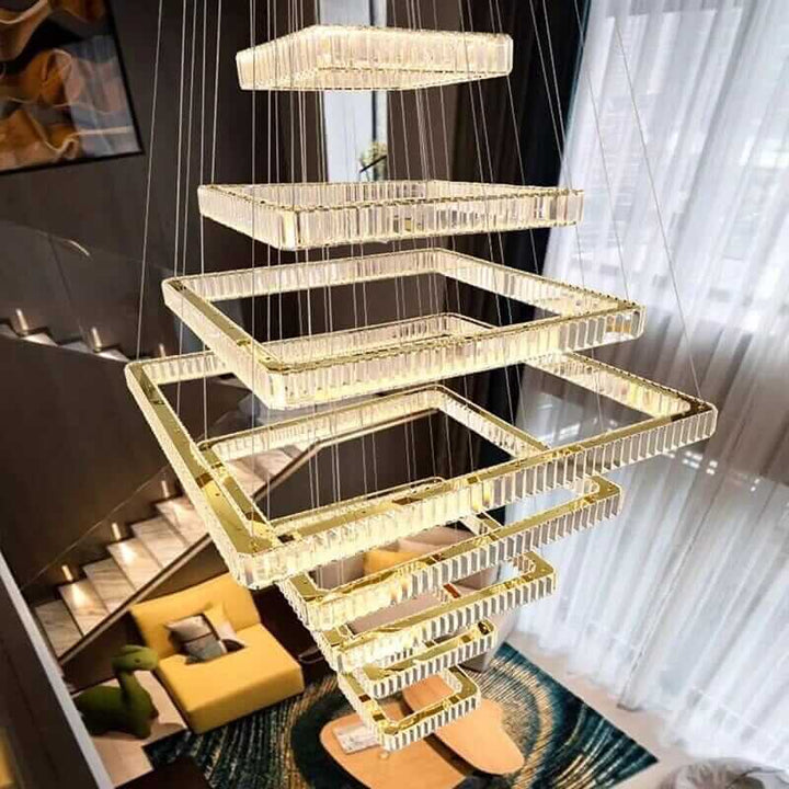 Modern LED staircase chandelier with a sleek square design, illuminating a stylish foyer.