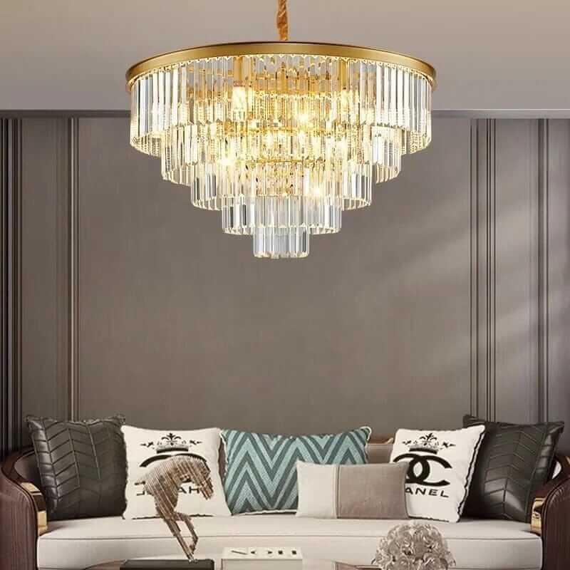 Elegant Badra Gemima Round Golden Crystal Chandelier illuminating a stylish living room with modern decor.