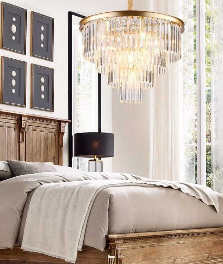 Luxurious Gemima Round Golden Crystal Chandelier illuminating a stylish bedroom with elegant decor.