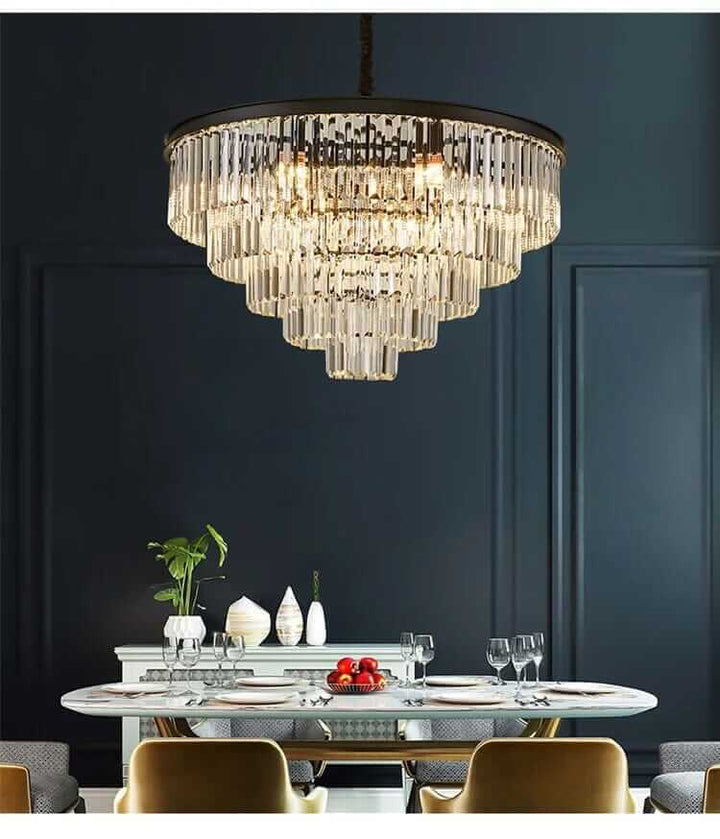 Gemima Round Golden Crystal Chandelier illuminating an elegant dining space with modern decor and stylish table setting.