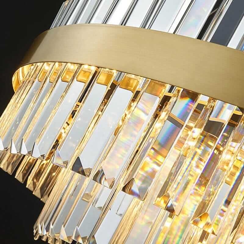 Close-up of a luxurious foyer chandelier with crystal accents and gold detailing, showcasing its elegant design.