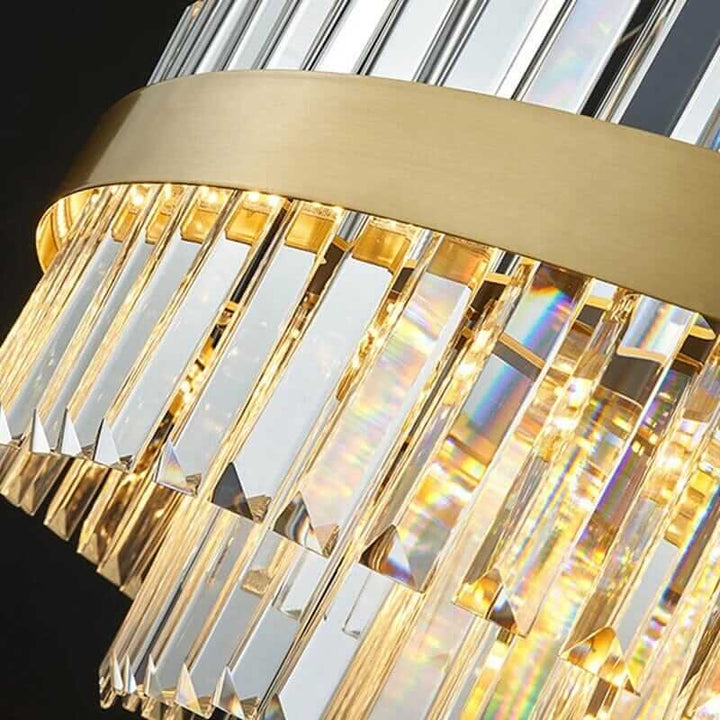 Close-up of a luxurious foyer chandelier with crystal accents and gold detailing, showcasing its elegant design.