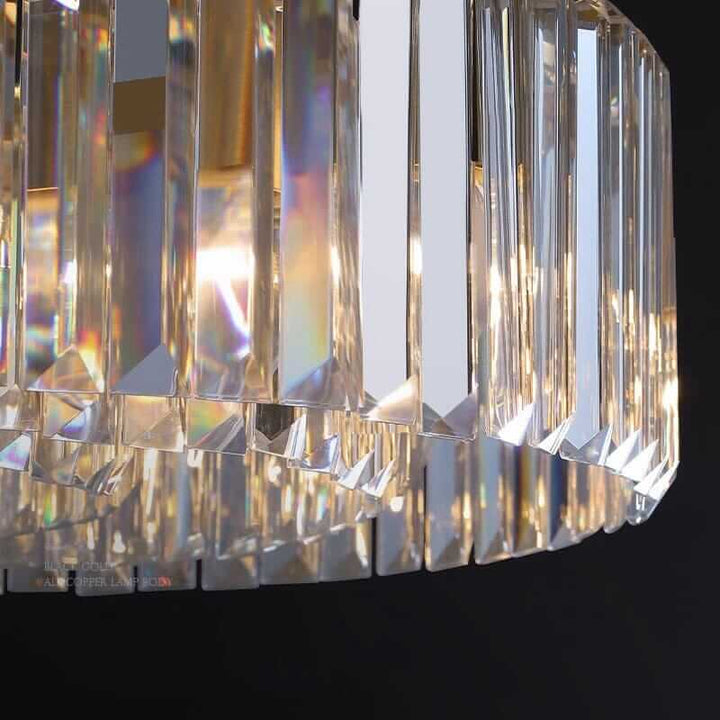 Foyer chandelier showcasing elegant crystal design, casting beautiful light reflections in a modern interior setting.