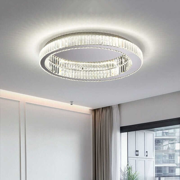 Modern round chandelier with crystal accents, providing elegant ambient lighting in a stylish interior setting.