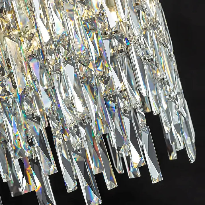 Close-up of a round chandelier featuring cascading crystal prisms that reflect light beautifully.