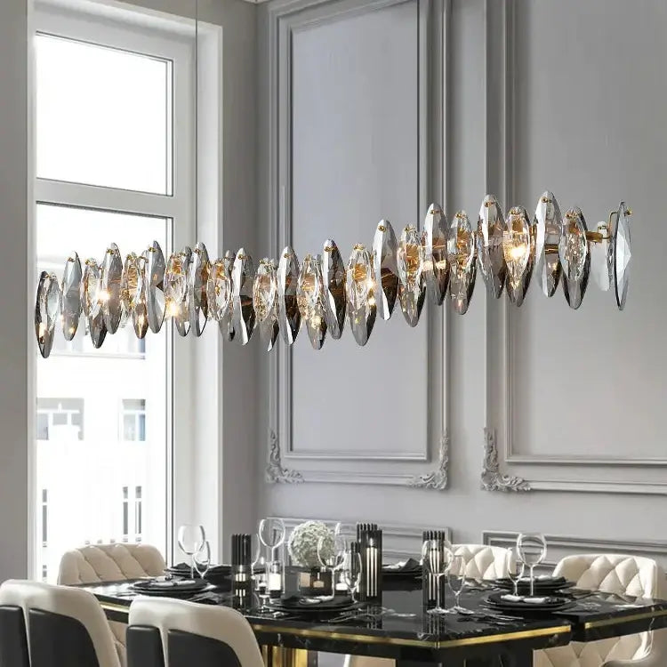 Long Restaurant Crystal Chandelier hanging above an elegant dining table in a modern setting.