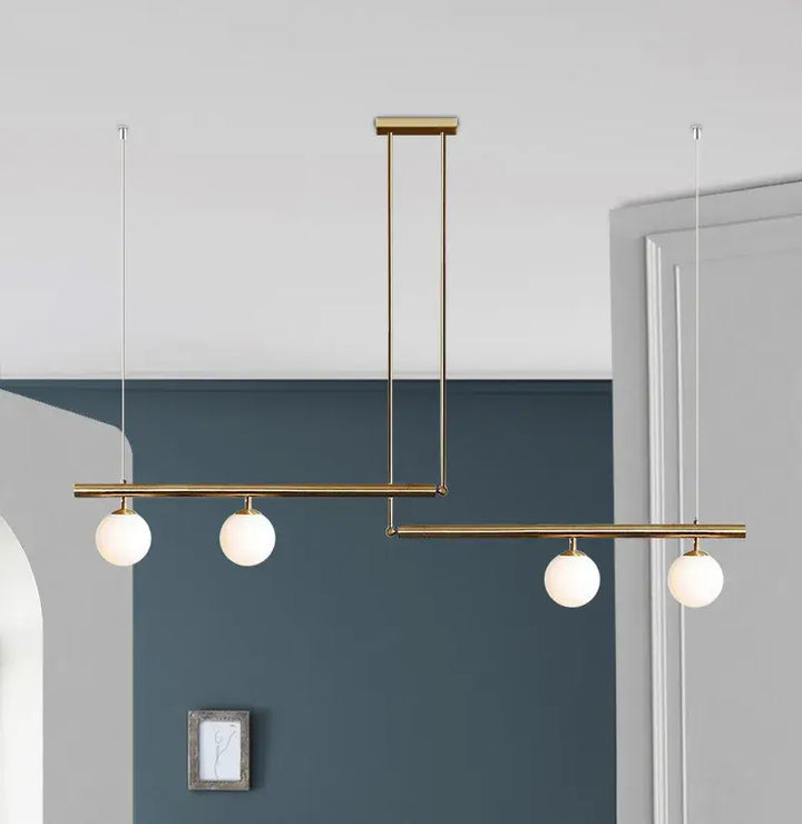 Black and gold modern chandelier with three frosted globes, perfect for kitchen islands.