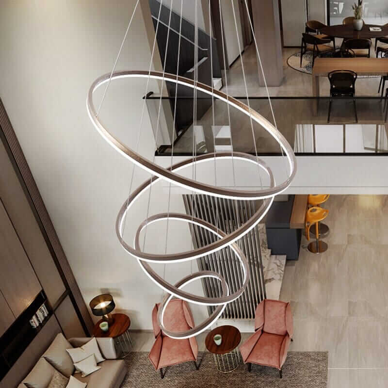 Gold and black chandelier with interlocking rings, showcasing elegance and modern design in a stylish interior.