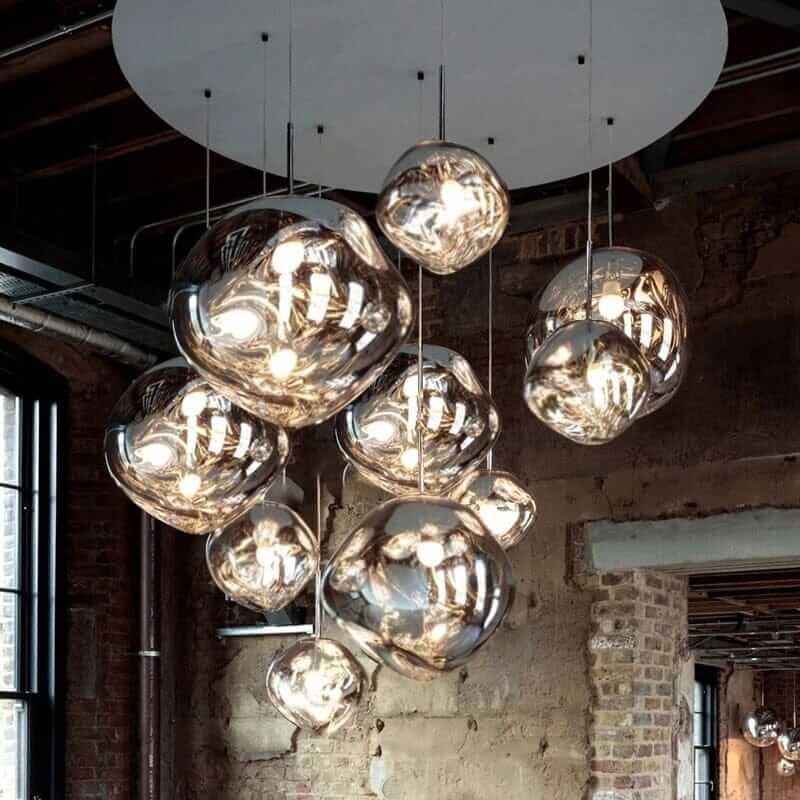 Modern foyer chandelier featuring cascading glass globes with warm lights, enhancing sophistication in home decor.