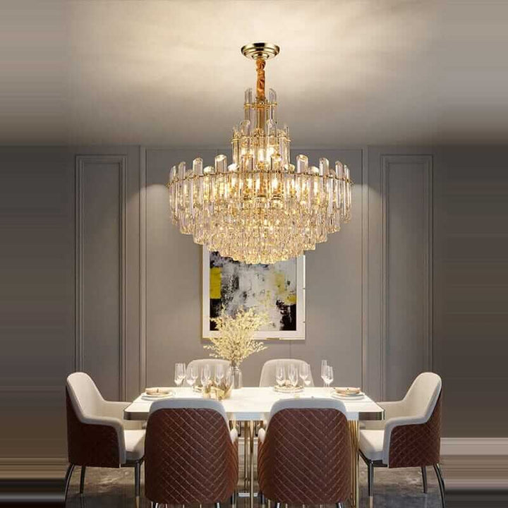 Elegant foyer chandelier lighting up a modern dining room, enhancing ambiance with its gold-plated polished brass design.