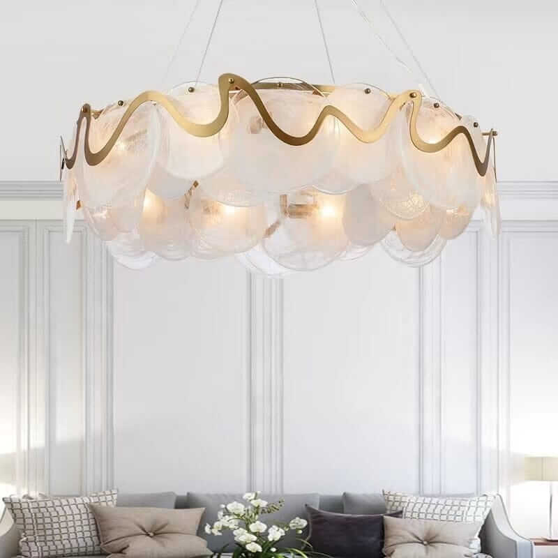Elegant gold chandelier with glass shades illuminating a stylish living room.
