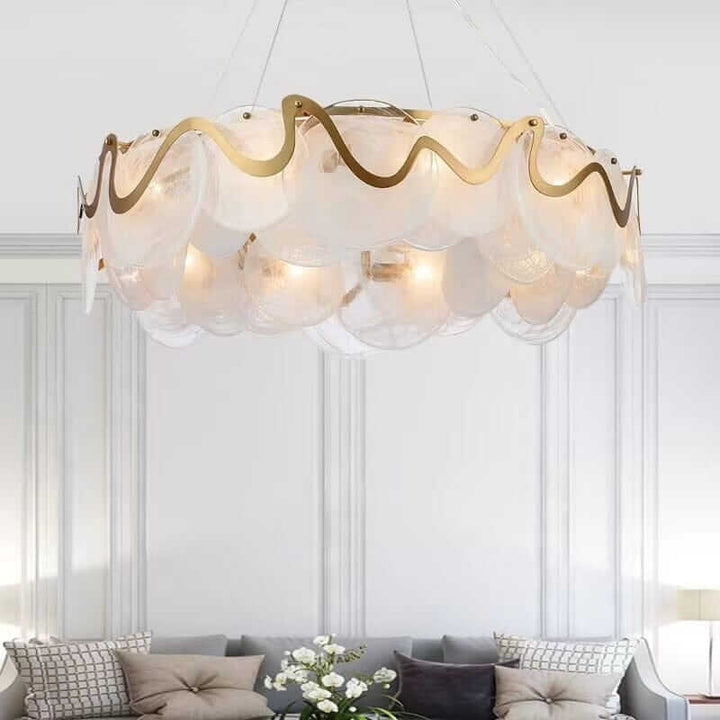 Elegant gold chandelier with glass shades illuminating a stylish living room.