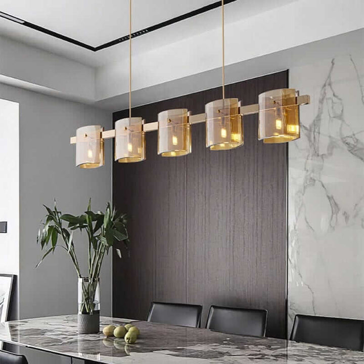 Modern LED chandelier with glass shades illuminating a dining area, creating a warm and inviting ambiance.