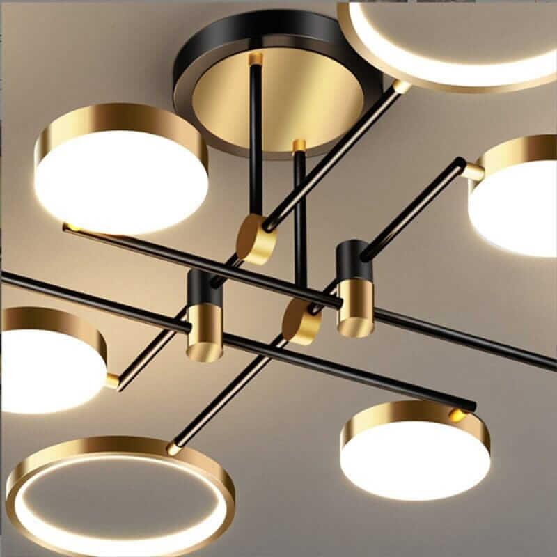 Modern black and gold chandelier with circular lights, perfect for creating a cozy atmosphere in living spaces.