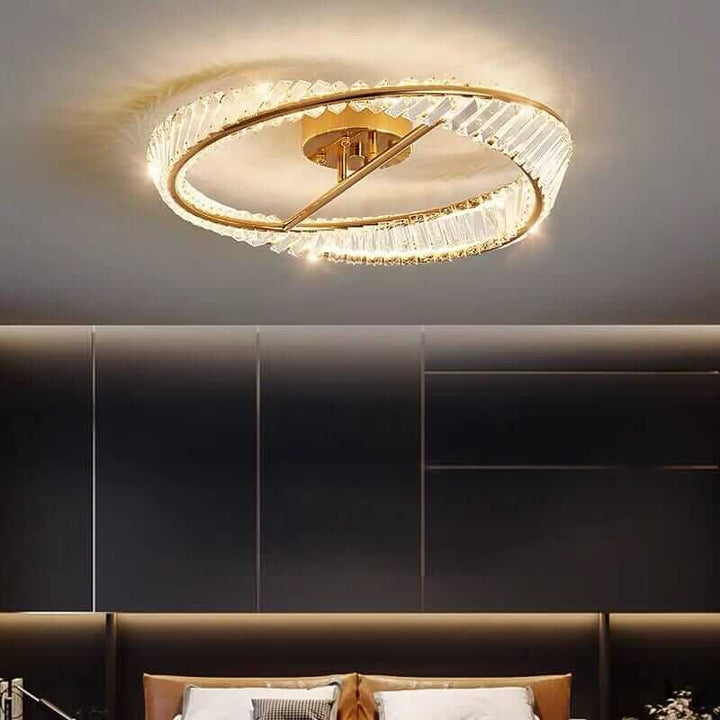 Elegant gold chandelier with crystal accents, illuminating a modern bedroom with a luxurious ambiance.