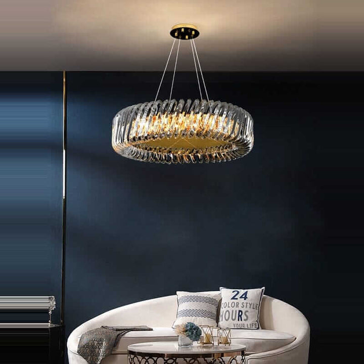 Stylish round chandelier with glass details and gold accents, illuminating a modern living space.