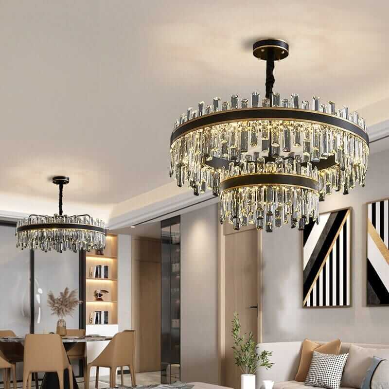 Elegant foyer chandeliers with crystal design illuminating a modern living space.