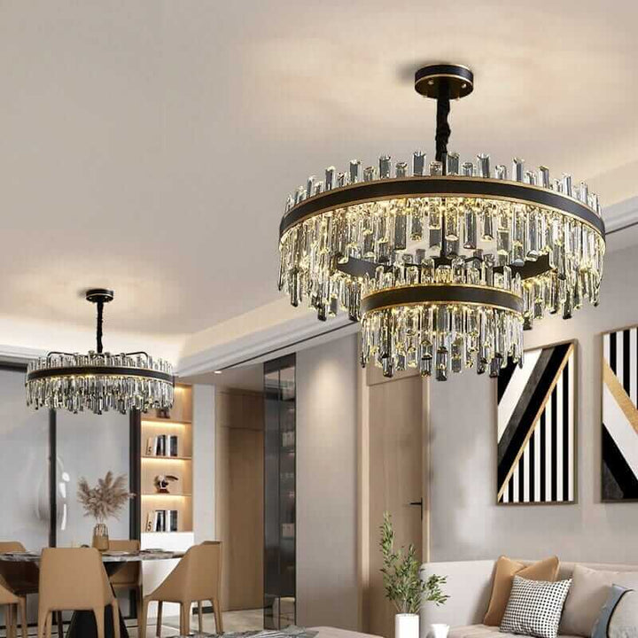 Elegant foyer chandeliers with crystal design illuminating a modern living space.